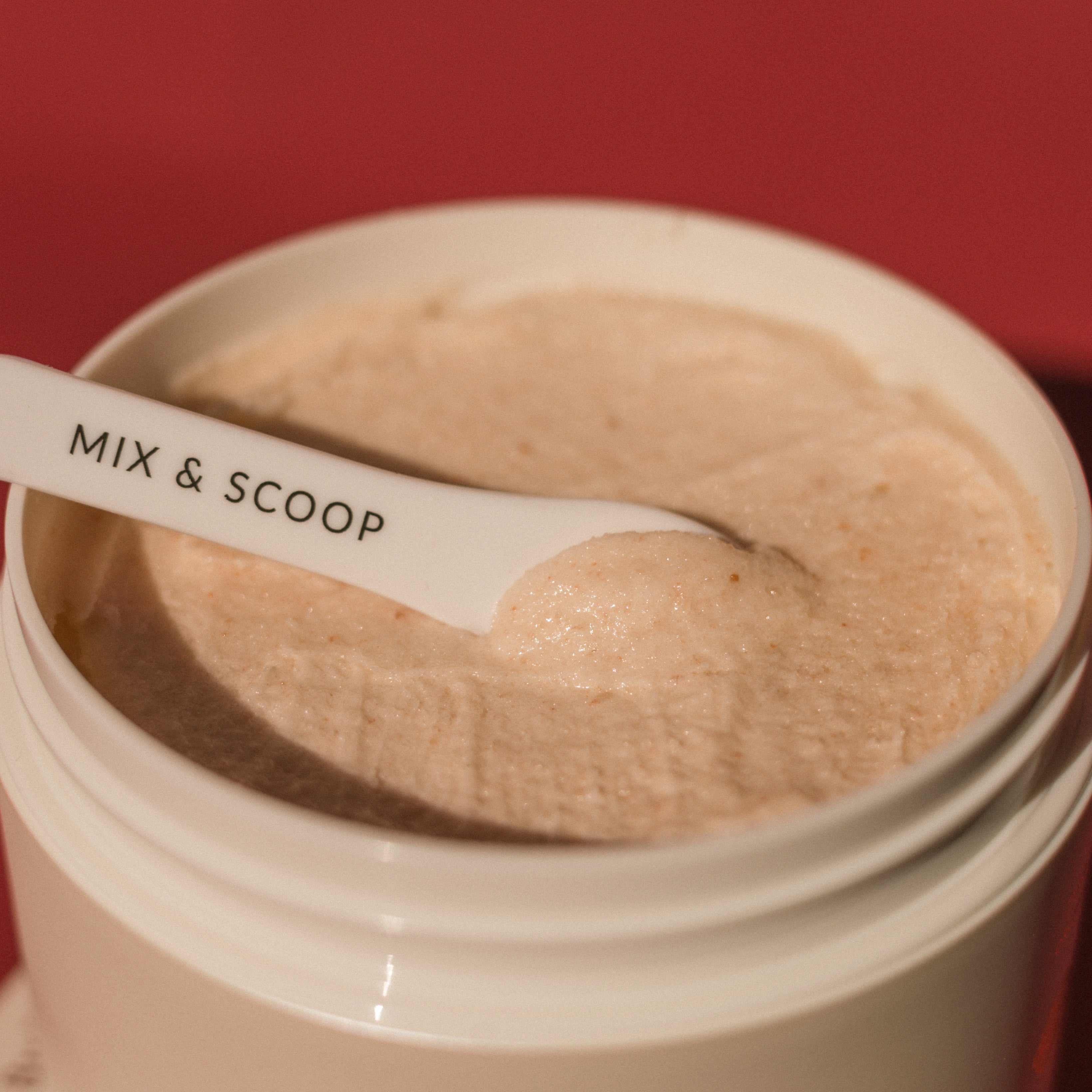 Pink Himalayan Salt Scrub close up texture with mix and scoop spatula